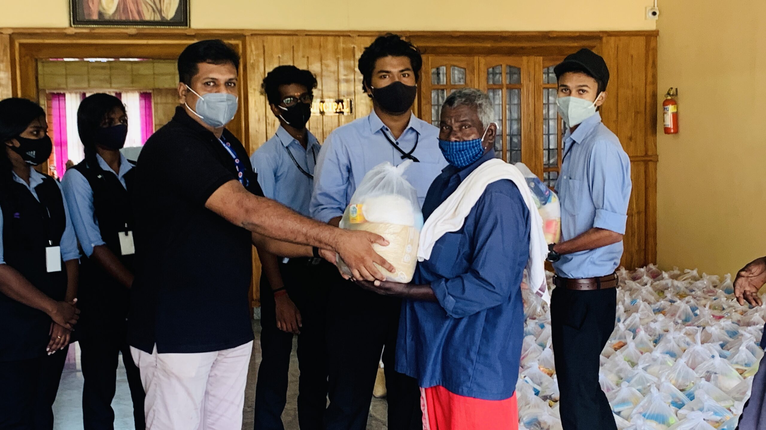 NSS Unit of Christ College Distributes Food Kits to Loading Workers